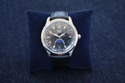 a watch that is sitting on top of a blue pillow