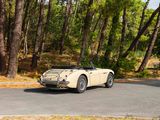 a car that is driving down the road in the woods