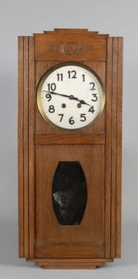 a wooden clock with a black face on a gray background