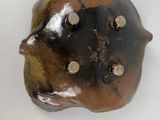 a brown and black object on a white surface