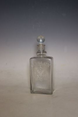 a small glass bottle with a silver lid