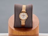 a watch that is sitting on top of a wooden stand