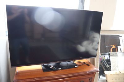 a flat screen tv sitting on top of a wooden dresser