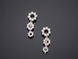 a pair of diamond and white gold earrings