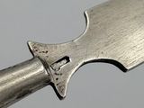 someone is holding a knife with a metal handle on a gray surface
