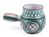 a green and brown cup with a handle on a white surface
