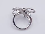 an image of a silver ring with a bow on top of it
