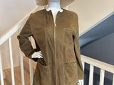 Le mannequin porte un chapeau et une veste dans l'escalier.