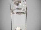 an old fashioned glass lantern with a candle inside of it