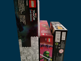 three boxes of legos sitting on a blue surface