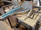a machine that is cutting a piece of wood on a table