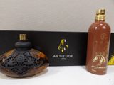 an image of a bottle of perfume next to a bottle of perfume