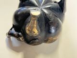 two black teapots sitting next to each other on a table
