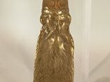 a gold statue of a man with a beard and a hat