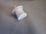 a white spool with a cork on it on a table