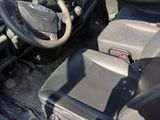 a red truck with a steering wheel and a black seat