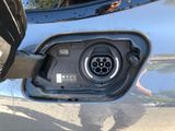 a close up of a car ' s fuel pump with a person standing next to it