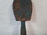 a wooden paddle that is sitting on a table