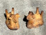two pieces of wood that have been carved into the shape of a giraffe ' s head