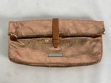 a close up of a purse on a table with a white background