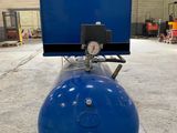 a blue tank sitting on top of a wooden pallet in a warehouse