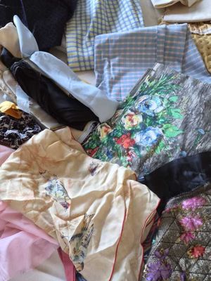 a lot of clothes that are laying on a bed