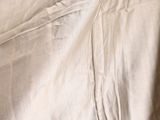 a close up of a bed with a white sheet on top of it