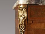 a wooden cabinet with a marble top and a door handle