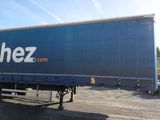 a large blue truck that is parked in a lot