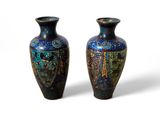 pair of blue and green vases sitting on a white surface