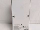 the back of a white refrigerator sitting on top of a white surface