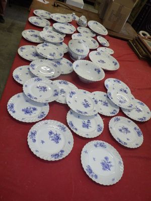 many plates on a table with a red table cloth