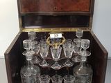 a wooden box with a bunch of glasses inside of it