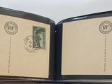 an open book with stamps on it sitting on a table