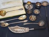 a lot of silver spoons and spoon spoons on a table