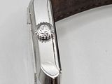 a close up of a watch on a white surface