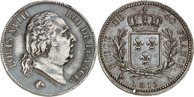 a silver coin with a crown on top of it