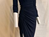 the mannequin is wearing a black dress with a high slit