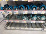 a lot of blue and silver pots and pans on the shelves