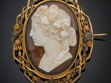 un camée ancien représentant une femme avec des fleurs dans les cheveux