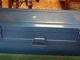 a blue tool box sitting on top of a green table