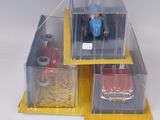a toy car and a toy truck in a display case