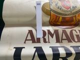 a sign that says armagua and a bottle of liquor on top of it