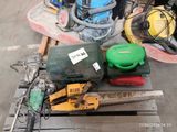a pile of assorted tools on a pallet in a warehouse