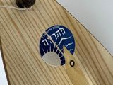 a skateboard with a sticker on it sitting on a table