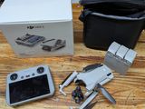 a box with a camera and a remote control on a table