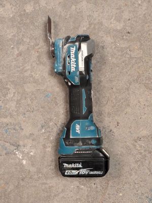 a cordless tool that is laying on the ground