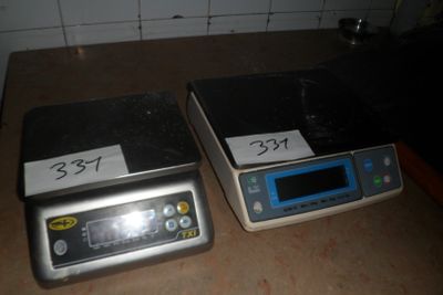 two electronic scales sitting on a counter top