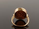 an image of a gold ring with a roman coin on it