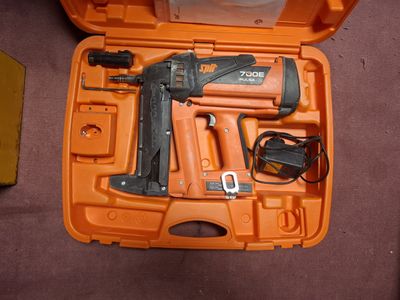 an orange case with a stapler and a stapler in it